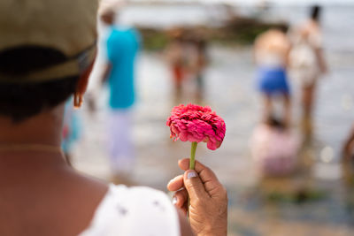 Believers of the camdonble religion are holding flowers to offer to iemanja in salvador, bahia.