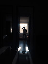 Silhouette man standing in darkroom