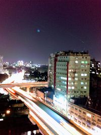 High angle view of illuminated buildings against sky at night