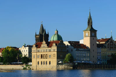 View of buildings in city against clear sky