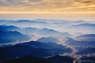 Scenic view of mountains against sky at sunset