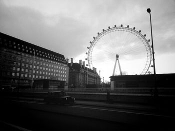 Ferris wheel against cloudy sky