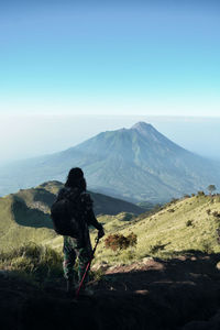 Rear view of man looking at mountains