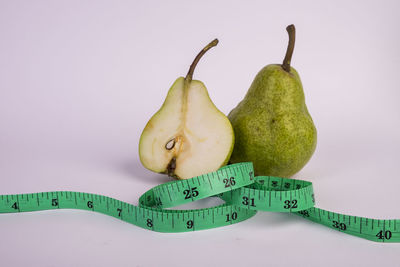 Close-up of bananas on table against white background