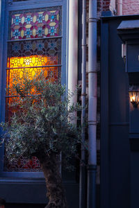 Illuminated building seen through window