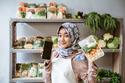 Portrait of young woman using mobile phone