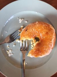 High angle view of donut with forks in plate on table