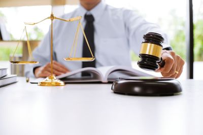 Midsection of man holding camera on table