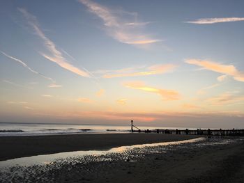 Scenic view of beach against sky during sunset