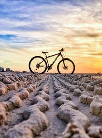 Bicycles on bicycle against sky during sunset