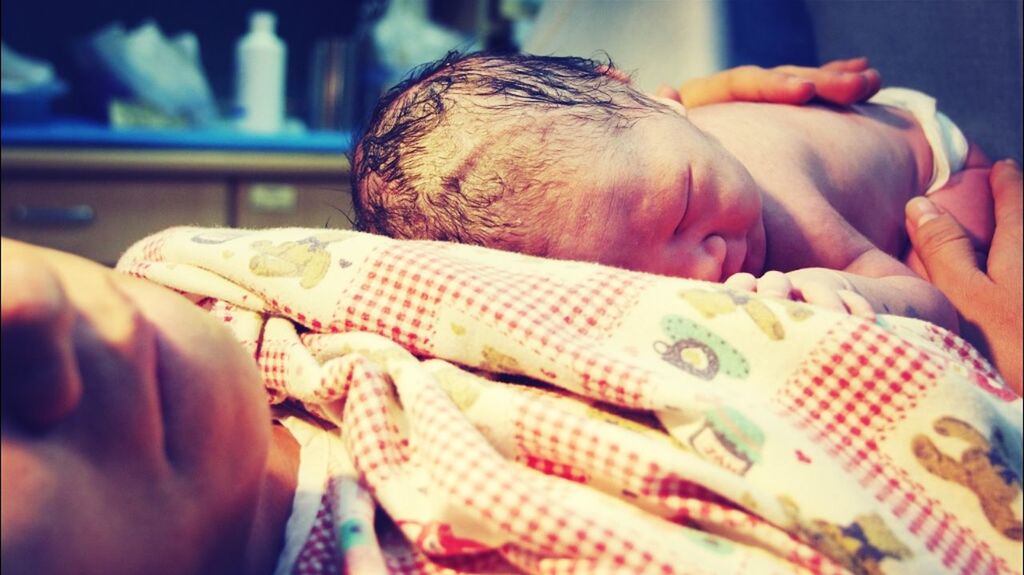 indoors, person, childhood, holding, baby, babyhood, lifestyles, close-up, midsection, unknown gender, bed, focus on foreground, innocence, leisure activity, part of, toddler