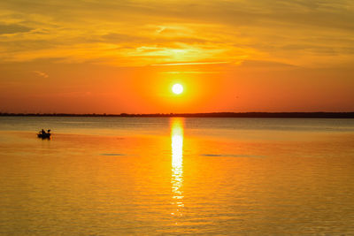 Scenic view of sea against orange sky