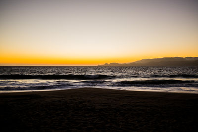 Scenic view of sea against clear sky during sunset