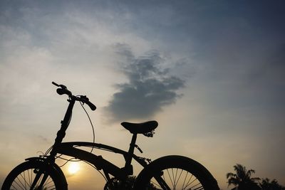Low angle view of silhouette bicycle against sky