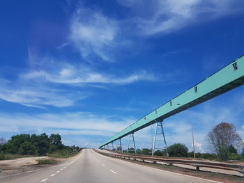 View of highway against cloudy sky