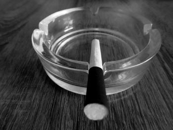 Close-up of cigarette in ashtray on table