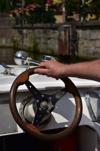 Close-up of person driving yacht