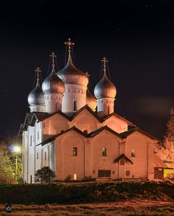 Illuminated cathedral against sky at night
