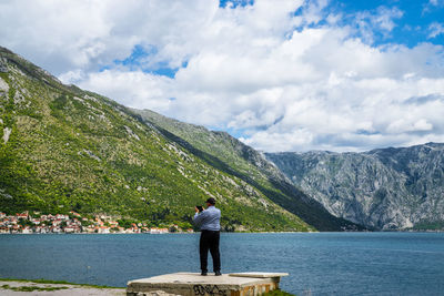 Rear view of man looking at lake