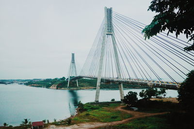 Low angle view of suspension bridge over river