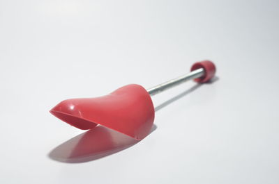 High angle view of red chili peppers over white background