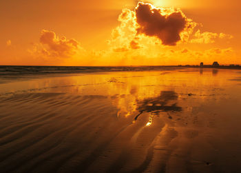 Scenic view of beach against sky during sunset