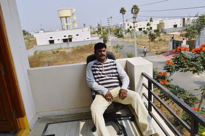 Portrait of a smiling young man sitting outdoors