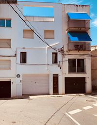 Exterior of building by street against blue sky