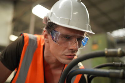 Rear view of man working in factory