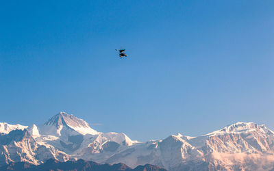 Scenic view of snowcapped mountains against clear blue sky