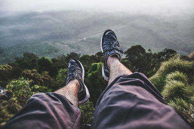 Low section of man relaxing on land