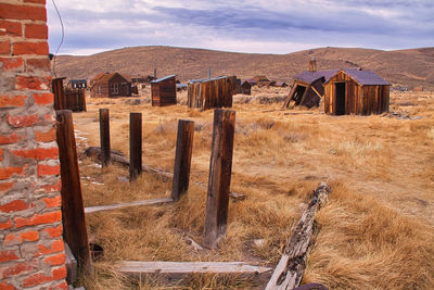 Old house on field against sky