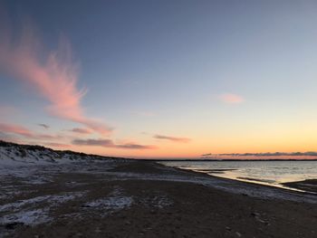 Scenic view of beach against sky during sunset