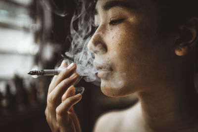 Close-up of woman smoking cigarette