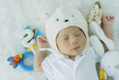 Cute baby girl sleeping on bed