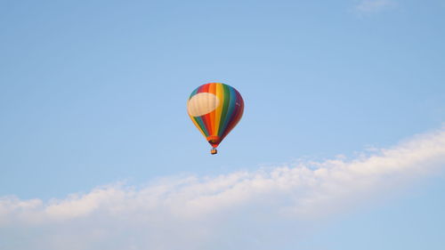 Low angle view of hot air balloon against blue sky
