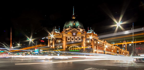 Light trails on road in front of filnders street station at night