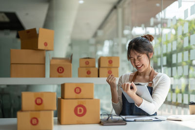 Young woman using mobile phone in office