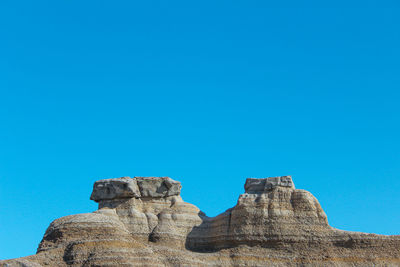 Rock formation against blue sky - drumheller alberta