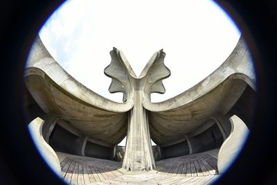 Low angle view of statue against temple against sky