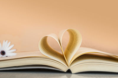Close-up of heart shape on book over table
