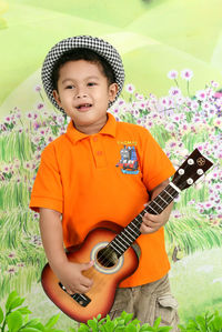 Portrait of boy playing guitar