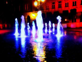 Reflection of illuminated buildings in water at night