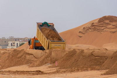 Buildings on desert against clear sky