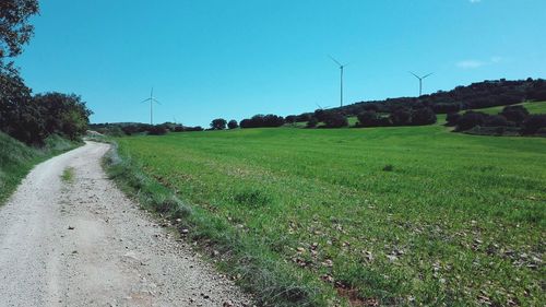 View of windmill on field against sky