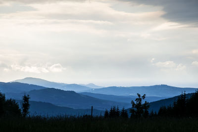 Scenic view of mountains against cloudy sky