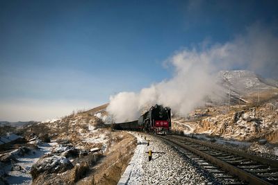 Railroad tracks on snow covered mountain