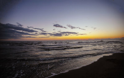 Scenic view of beach against sky during sunset