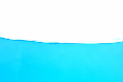 Close-up of blue water against white background