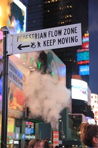 Illuminated information sign in city at night